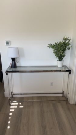 Modern Acrylic & Chrome Glass Console Table  Beautiful modern console table featuring clear acrylic legs, polished chrome accents and a glass top.  Sl