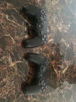 Two Black PS4 DualShock 4 Controllers