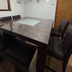 Dark brown wooden square dining table with upholstered seats