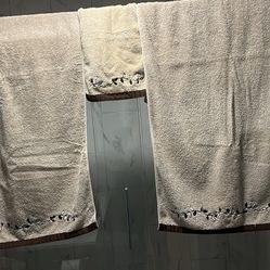 Towel set. Two bath towels and one hand towel. Beige and brown