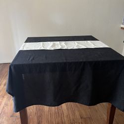 Wooden Dining Table with Black Tablecloth