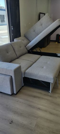 New sleeper sectional sofa with 2 stools, and a storage chaise lounge on sale now don't miss