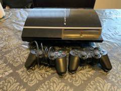 Playstation 3 with 2 remotes & 7 games