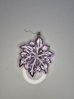 Pink metallic poinsettia flower Christmas ornament featuring white glitter accents and a decorative beaded center. A pretty statement ornament for a C