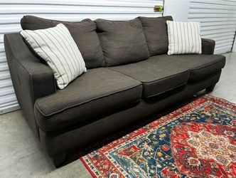 Levon Charcoal Sofa By Signature By Ashley With Matching Pillows Including Delivery