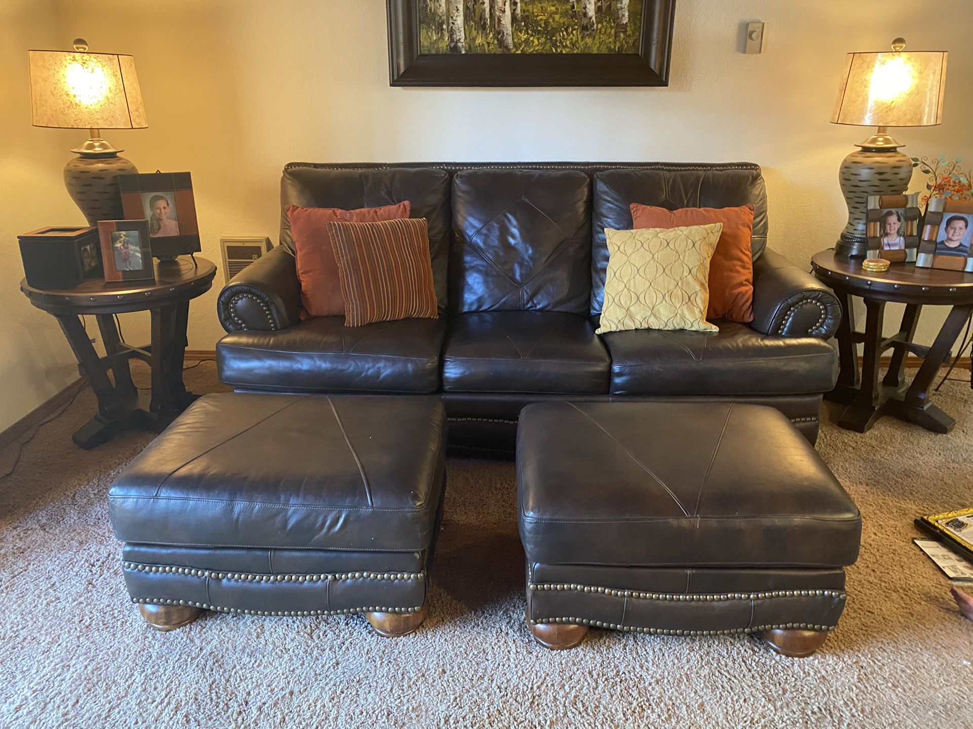Leather couch with hide-abed and two ottomans and pillows