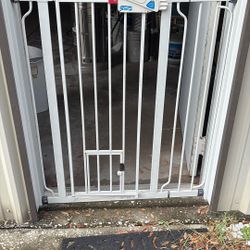Extra Tall Doggie Gate Can Go From 29 Inch To 40 Inch Door WY.  Also Has A Small Doggie Door At The Bottom 