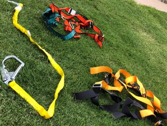 Shock absorbing lanyards with harness