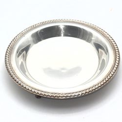 vintage silver serving bowl with a detailed rim is a stunning piece of American-made decor from 1948. Crafted by WM Rogers 