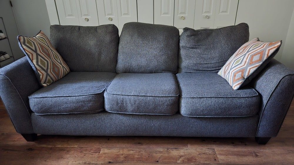 Gray Three-Seat Sofa with Pillows