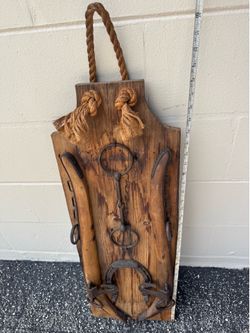 decorative mounting of antique horse hames / harness hardware mounted on reclaimed wood