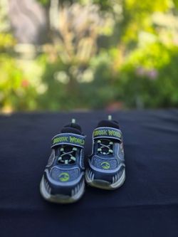 Black and green sneakers with dinosaur design. Dinosaur Themed Jurass8c Park Light Up ShoesKids Sneakers Size 11