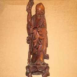 hand-carved wooden statue of Shou Lao, also known as Shouxing, the Chinese God of Longevity. 