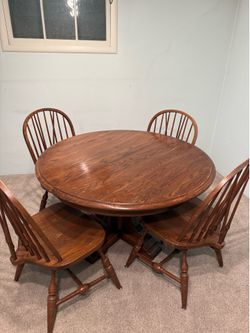 Solid Oak table with 1 leaf and 4 chairs.