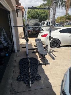 Bench press/squat rack with 7ft 45lbs bar plus 255lbs of Olympic weights and curl bar