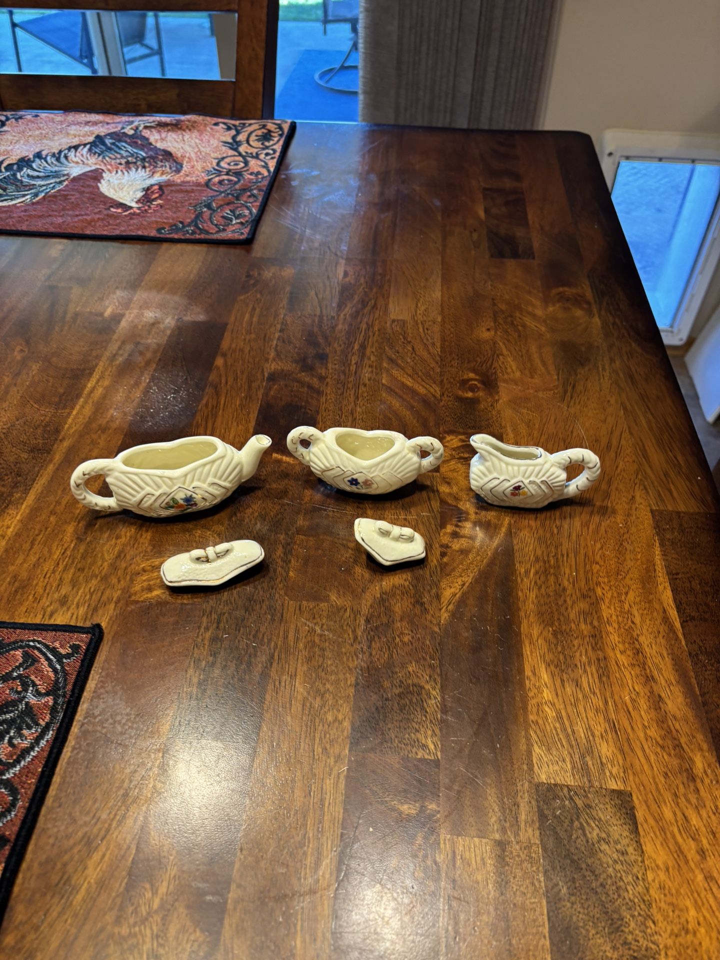 Vintage miniature tea, sugar, and creamer set.