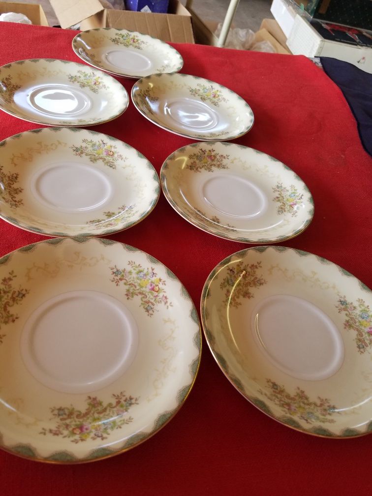 Meito China made in Japan hand painted, white and cream colors with floral sprays, tan scroll, green rim and gold trim 7 saucers A56V889