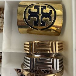 $130 bundle all 4 bracelwt : $50 top thick gold tone Tory bracelet, $40 each middle gold/silver tone fitbit tory burch, $25 bottom gold tone Tory Burc