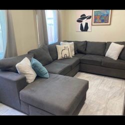 LIVING SPACES Beautiful Dark Grey Sectional Couch With Reversible Chaise 