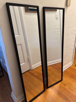 Two modern black mirrors