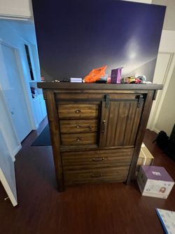 Chest of drawers with sliding door and shelves