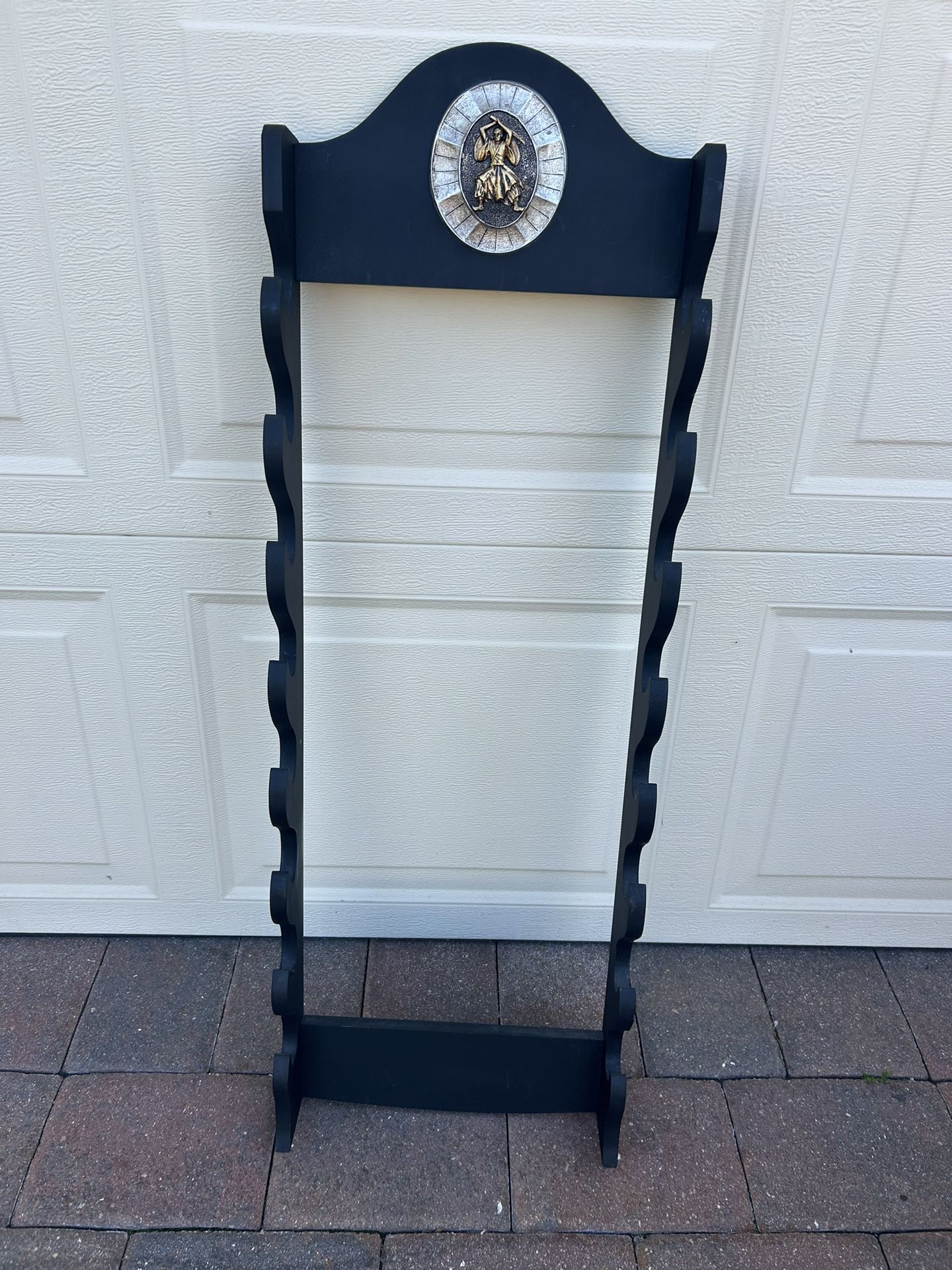 Samurai sword wall rack holds 8 swords 40 x 13.5 “ Black wood with medallion