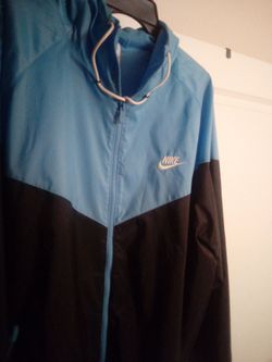 Black Nike jacket and black and light blue Nike jacket