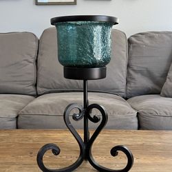 Candle glass and iron holder.