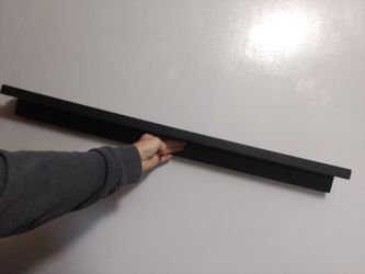 Wooden picture shelf with slots to insert frames