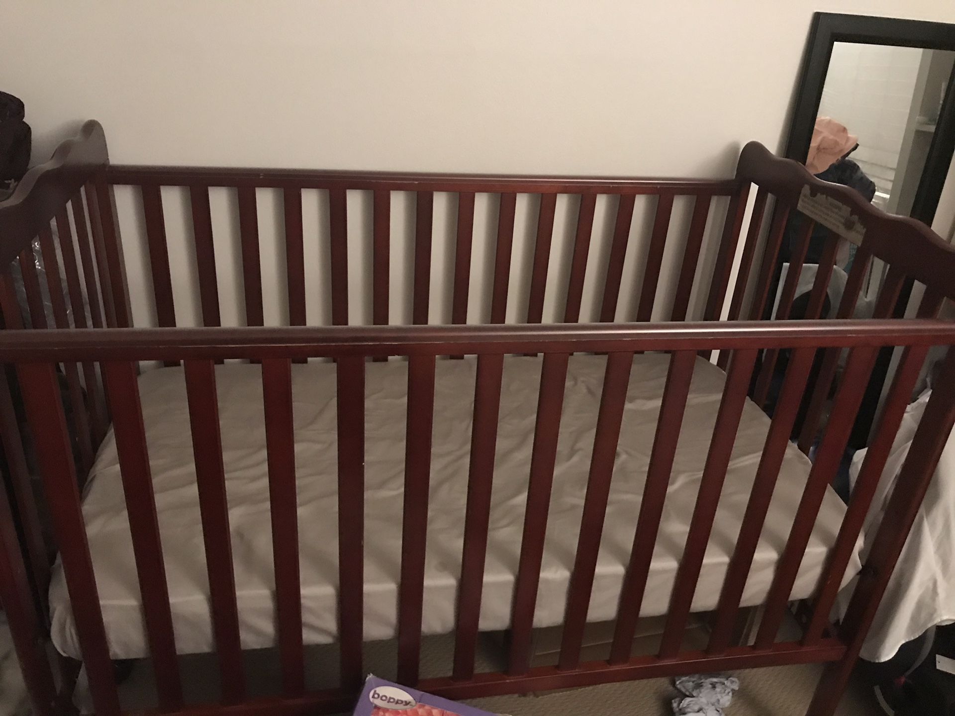 Wooden baby crib with mattress