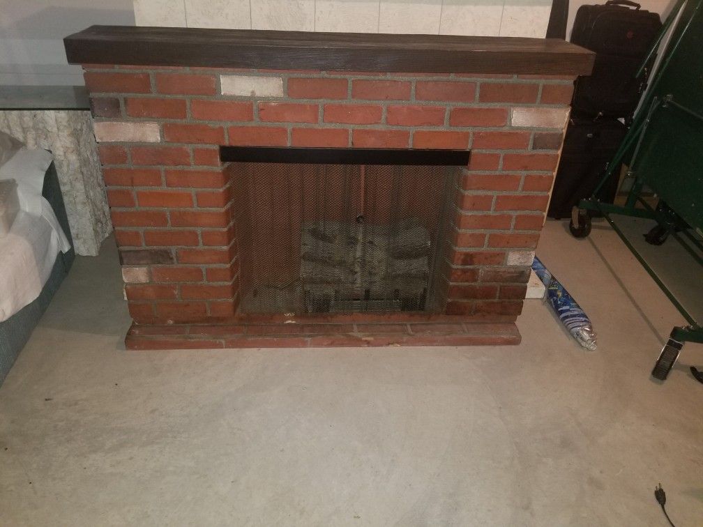 Decorative brick fireplace with fire logs that glow with fire and blows heat $400 obo