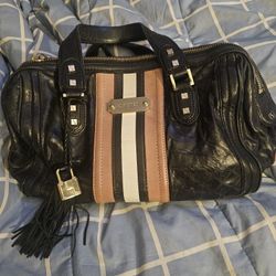 Black leather satchel handbag by L.A.M.B. Gwen Stefani, often identified as the Rocksteady model-$500