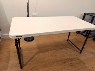 Adjustable height fold-in-half Table