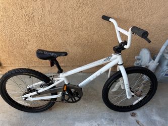 GT BMX bicycle with 20-inch wheels, black accents, and silver crankset.