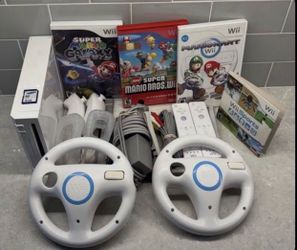 NINTENDO WII with 4 Games, 2 Wheels,2 Remotes
