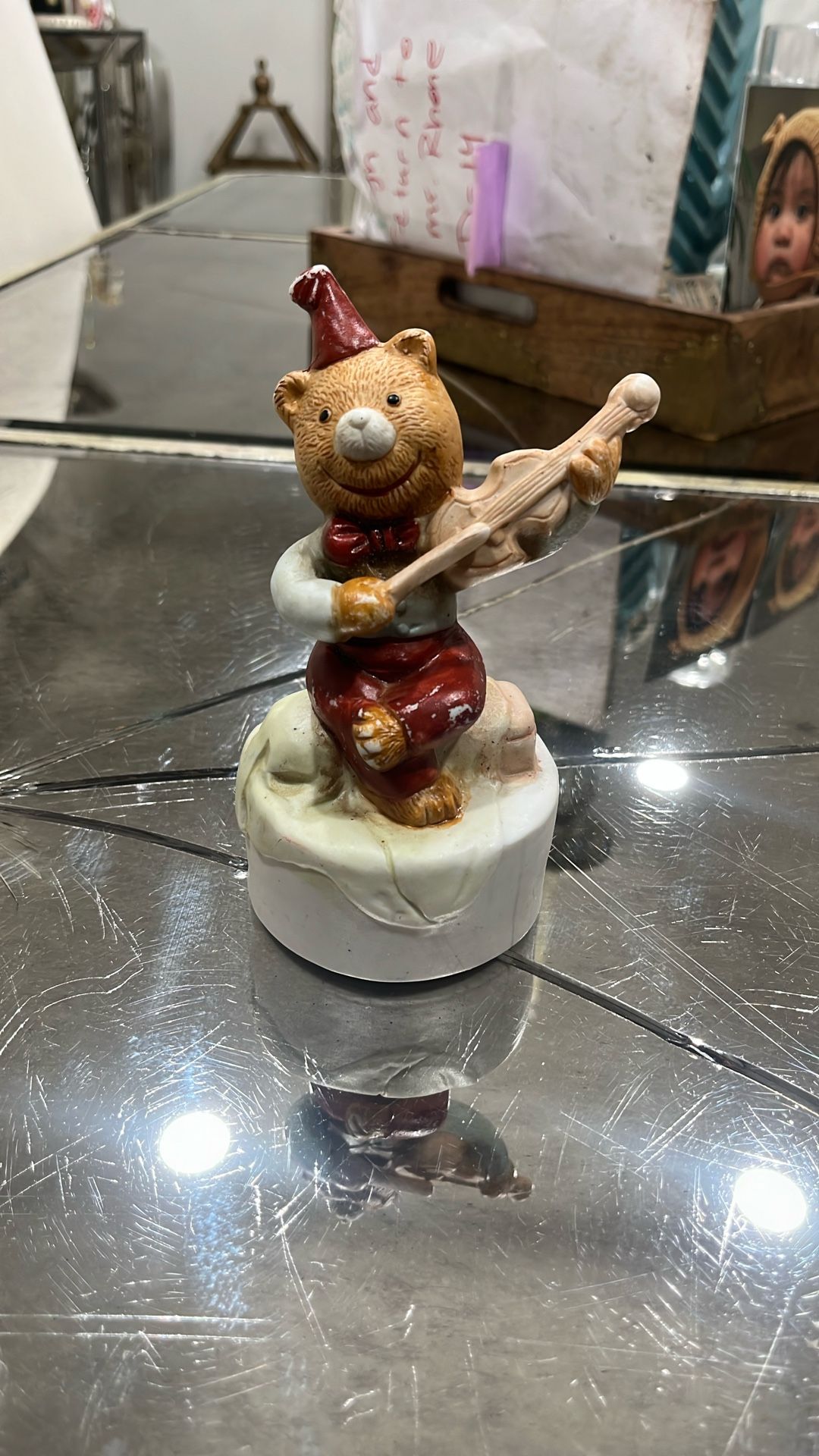 A vintage, figuring of a bear, playing a violin