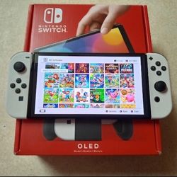 SWITCH OLED with 100 Switch games Mario Party,Mario Kart,Polemon,Zelda,Mortal Kombat and More