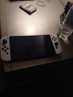 White Nintendo switch oled only detail is left joycon is broken but everything else is good