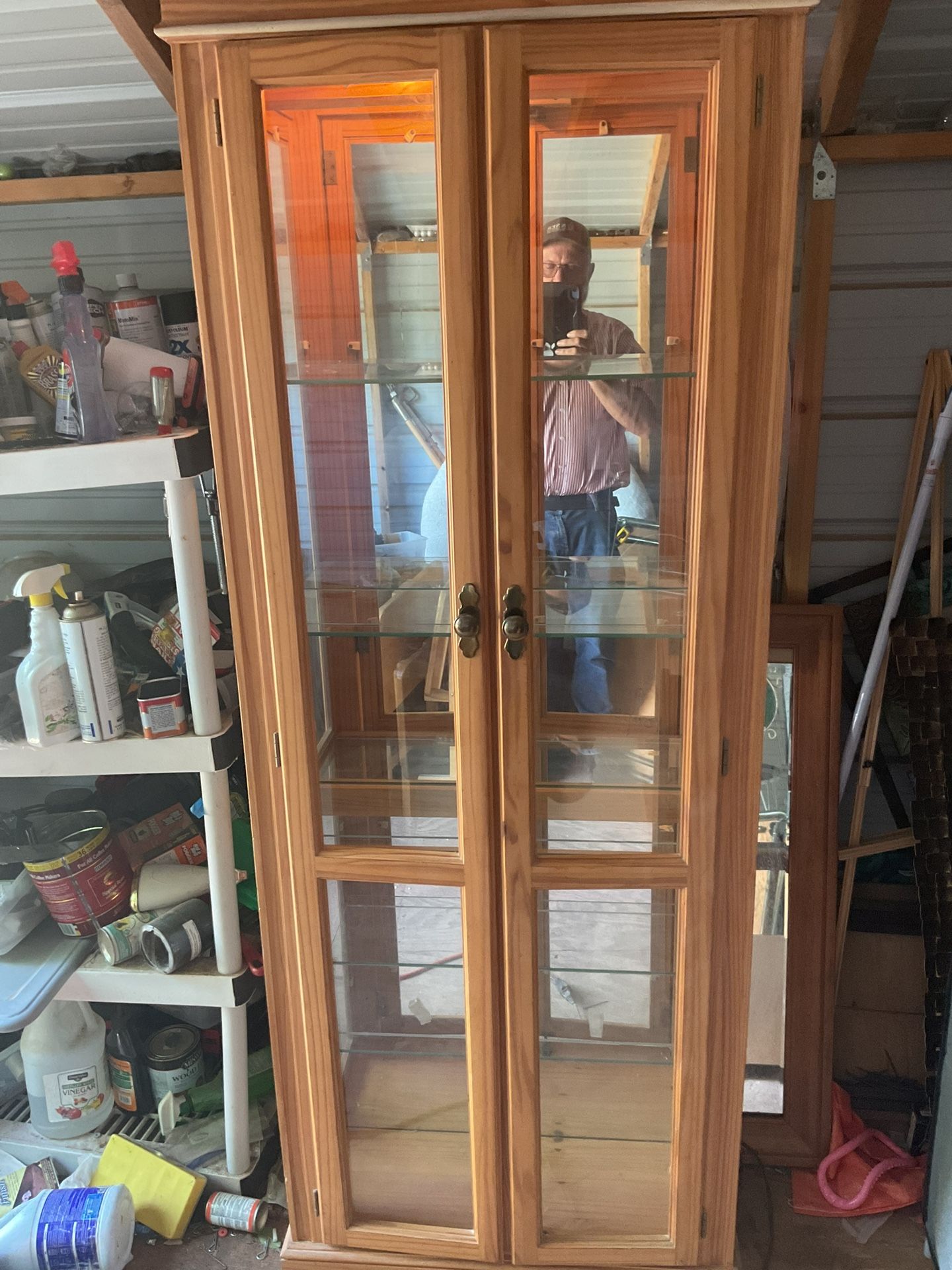 Lighted display cabinet it’s 77 inches tall 28 inches wide and 10 inches wide