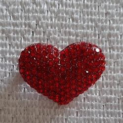 Red heart-shaped rhinestone brooch.