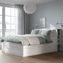 White IKEA BRIMNES queen-sized bed frame is made of particleboard and fiberboard