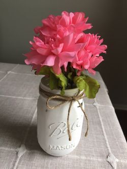 Distressed mason jar with silk flowers