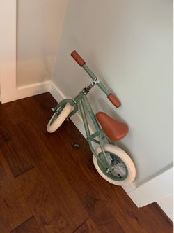 Green balance bike, helmet, and basket - like new