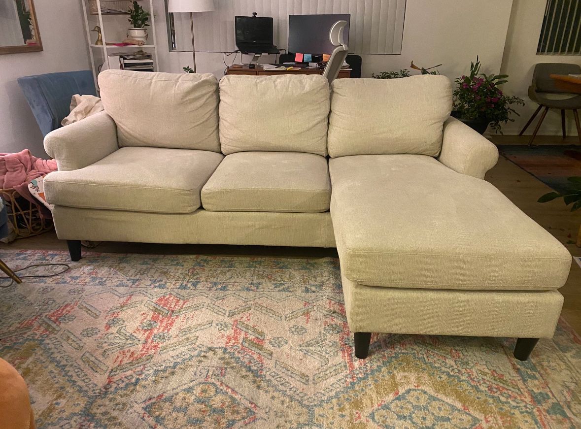 White Living Spaces 84” Sectional Sofa with Reversible Chaise