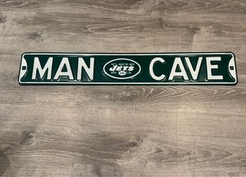 The image shows a green-and-white New York Jets Steel Street Sign with Logo-MAN CAVE made of embossed steel measuring approximately 6" x 36".
