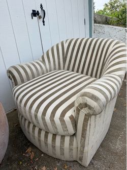 Barrel chair/tub chair/club chair) with a classic rounded/curved back, rolled arms, and vertical taupe/beige + cream stripes. It’s a common transition
