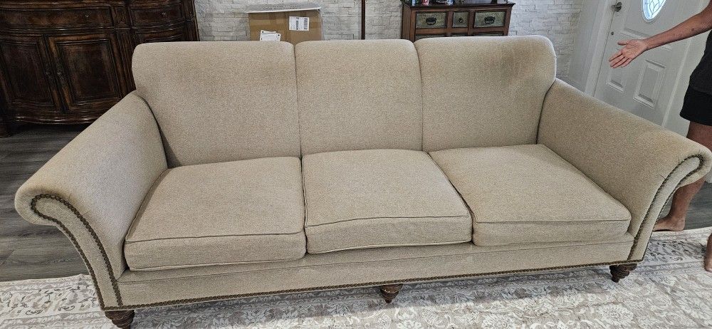 Beautiful 8-foot upholstered sofa rolled arms brown wood feet
