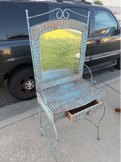 This is a vintage wrought iron and wicker vanity table, often styled with a distressed teal or light blue paint finish.