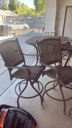 Outside table with four barstools