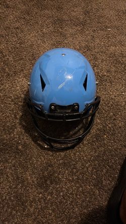 Blue and black shirt, football helmet